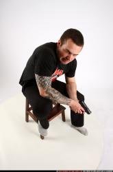 Man Adult Athletic White Fighting with gun Sitting poses Casual