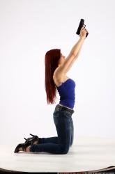 Woman Young Athletic White Fighting with gun Kneeling poses Casual