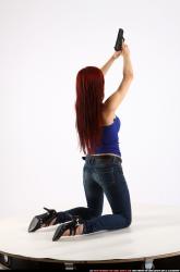 Woman Young Athletic White Fighting with gun Kneeling poses Casual