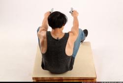 Man Young Athletic Fighting with gun Sitting poses Casual Asian