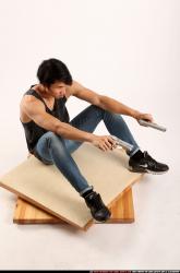 Man Young Athletic Fighting with gun Sitting poses Casual Asian