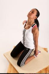 Woman Young Athletic Fitness poses Kneeling poses Sportswear Latino