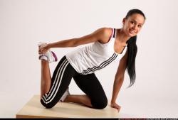 Woman Young Athletic Fitness poses Kneeling poses Sportswear Latino