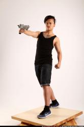 Man Young Athletic Fighting with submachine gun Standing poses Casual Asian