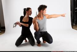 Man & Woman Adult Athletic White Fighting with gun Kneeling poses Casual