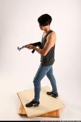 Man Young Athletic Fighting with submachine gun Standing poses Casual Asian