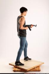 Man Young Athletic Fighting with submachine gun Standing poses Casual Asian