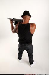 Man Adult Athletic Black Fighting with submachine gun Standing poses Casual