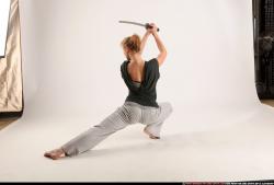 Woman Adult Athletic White Fighting with sword Kneeling poses Sportswear