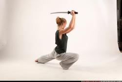 Woman Adult Athletic White Fighting with sword Kneeling poses Sportswear