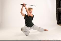 Woman Adult Athletic White Fighting with sword Kneeling poses Sportswear