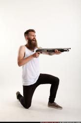 Man Adult Athletic White Kneeling poses Casual Fighting with shotgun
