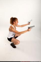 Woman Adult Athletic White Fighting with gun Kneeling poses Sportswear