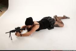 Woman Young Average White Fighting with submachine gun Laying poses Casual