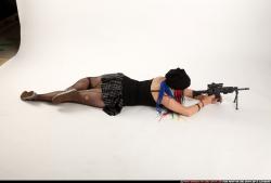 Woman Young Average White Fighting with submachine gun Laying poses Casual