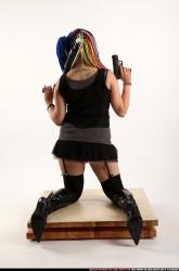 Woman Young Average White Kneeling poses Casual Fighting with shotgun