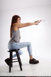 Woman Adult Athletic White Fighting with gun Sitting poses Casual