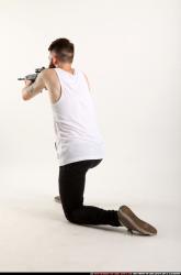 Man Adult Athletic White Fighting with submachine gun Kneeling poses Casual
