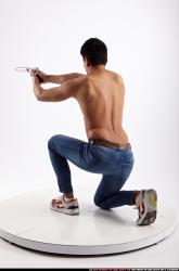 mack-kneeling-aiming-pistol