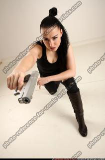 claudia-kneeling-aiming-pistol