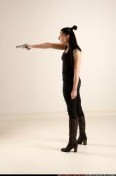 claudia-standing-threatening-pistol