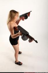 Woman Young Average Fighting with submachine gun Standing poses Asian