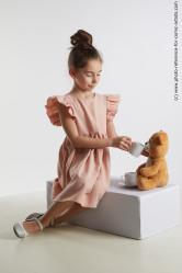 Sitting little girl with teddy bear Doroteya